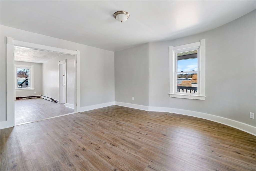 142 Spruce Street Winchendon, MA 01475 - Photo 27 of 34 a view of an empty room with wooden floor and a window