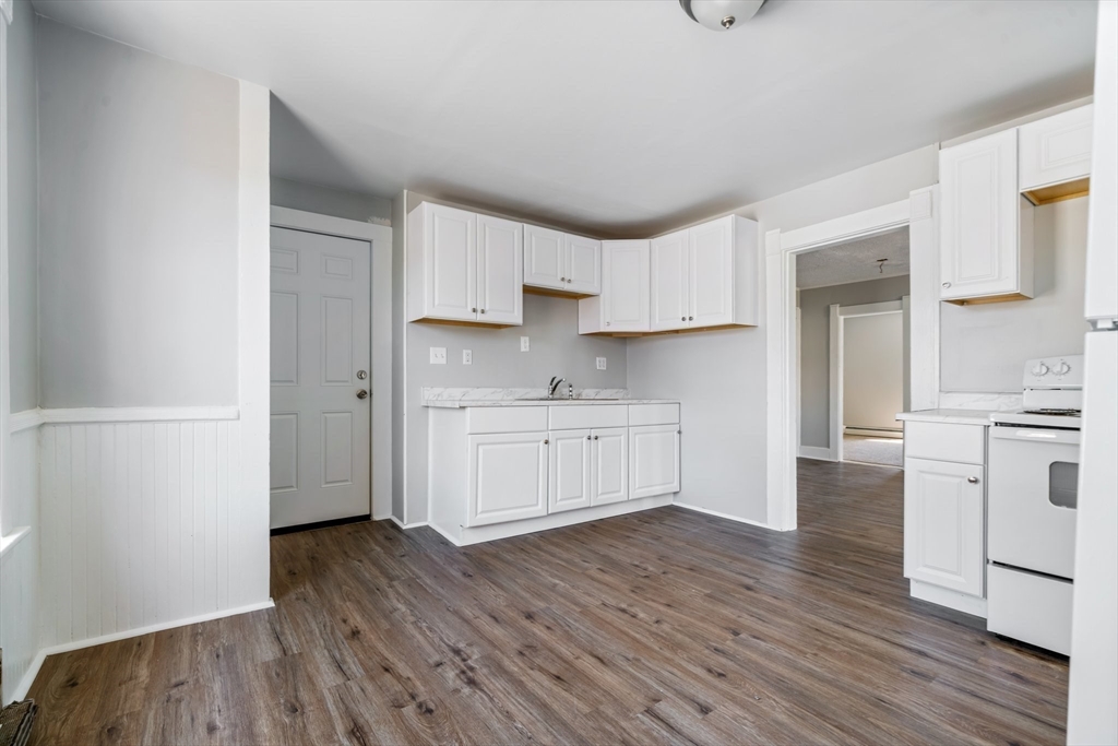 142 Spruce Street Winchendon, MA 01475 - Photo 6 of 34 a kitchen with white cabinets and white appliances