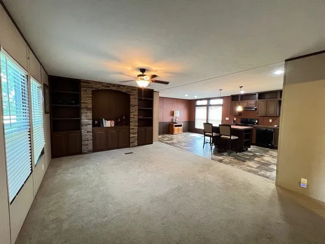 a view of a livingroom with furniture and a kitchen