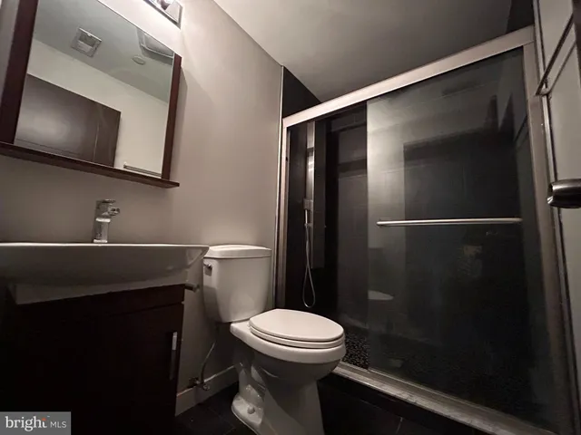 a bathroom with a toilet a sink and shower