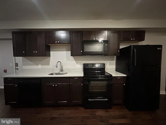 a kitchen with a sink and refrigerator