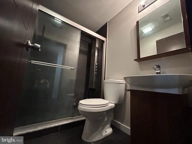 a bathroom with a sink toilet and a mirror