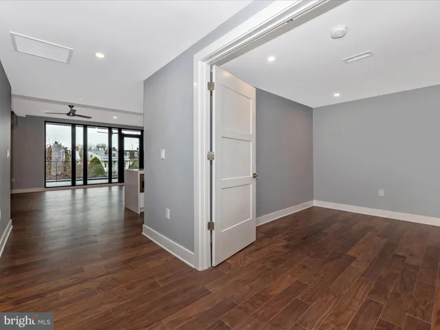 a view of a room with wooden floor