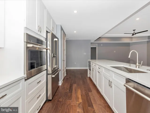 a view of a room with wooden floor