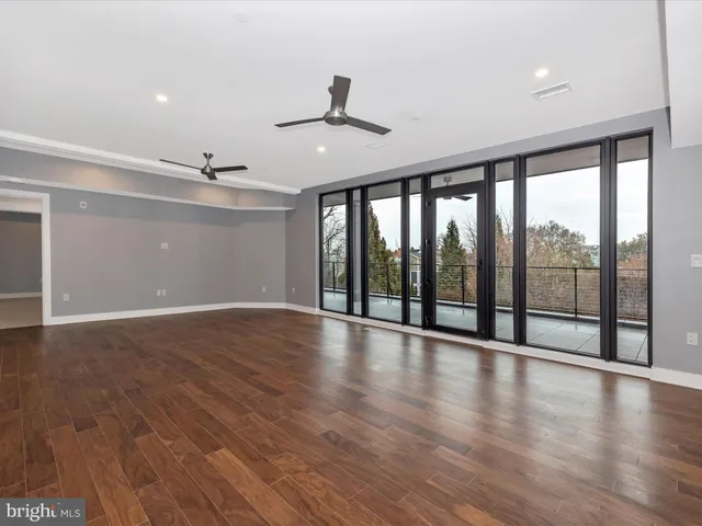 a kitchen with stainless steel appliances white cabinets and wooden floors