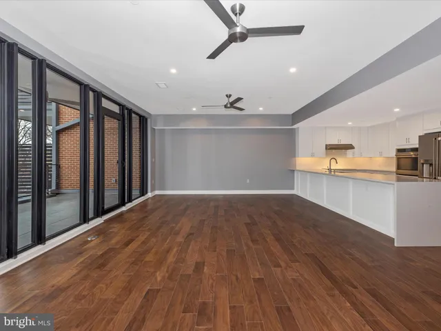a spacious bedroom with a bed and glass window