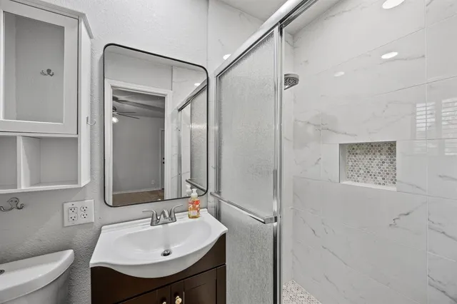 a bathroom with a sink toilet and shower
