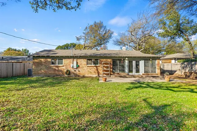 a view of a house with a yard patio and swimming pool