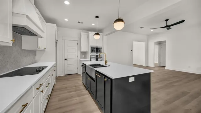 a kitchen with cabinets appliances and a counter top