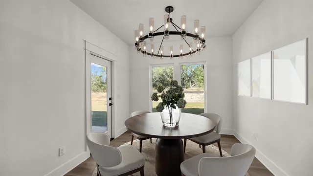 a very nice looking room with a large window and wooden floor