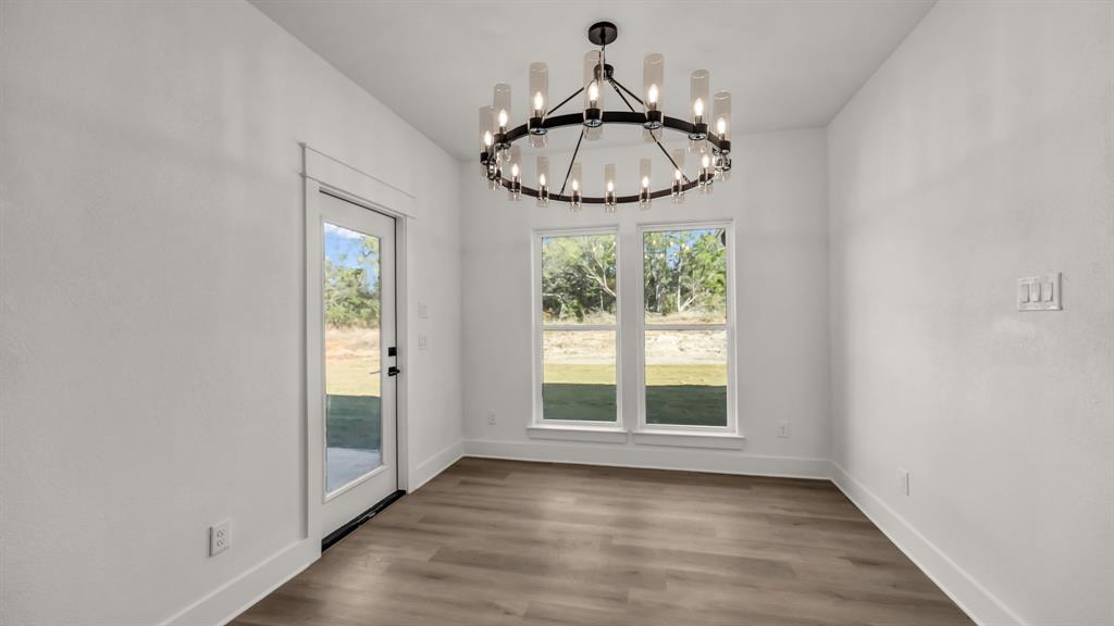 225 Jefferson Way Weatherford, TX 76088 - Photo 17 of 35 a very nice looking room with a large window and wooden floor
