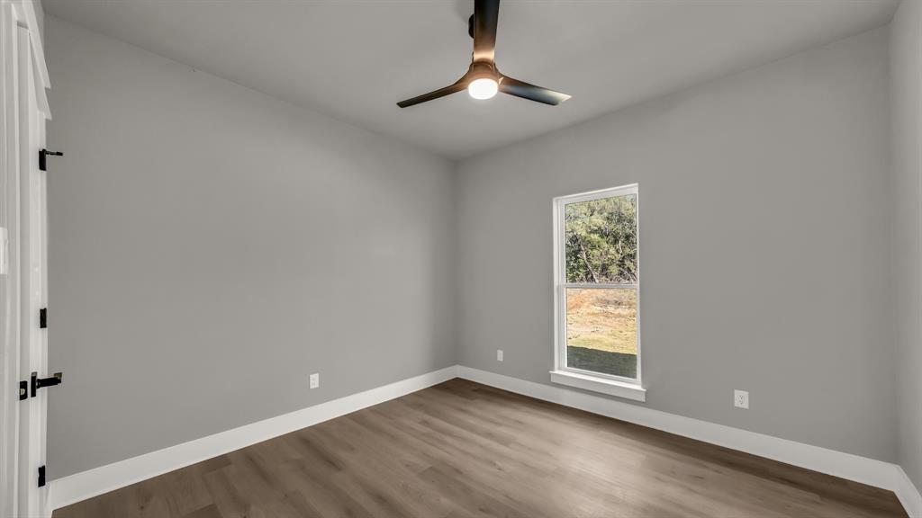 225 Jefferson Way Weatherford, TX 76088 - Photo 27 of 35 a view of an empty room with window and chandelier fan
