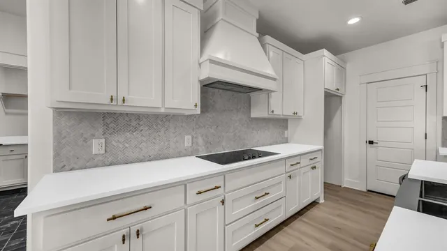 a kitchen with white cabinets and white appliances