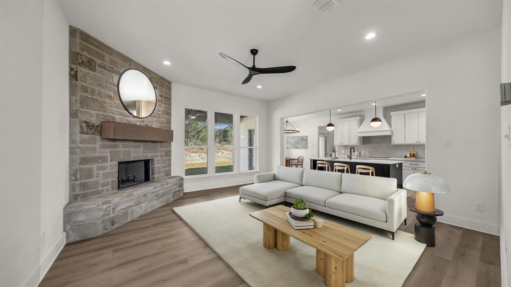225 Jefferson Way Weatherford, TX 76088 - Photo 4 of 35 a living room with furniture a fireplace and a large window