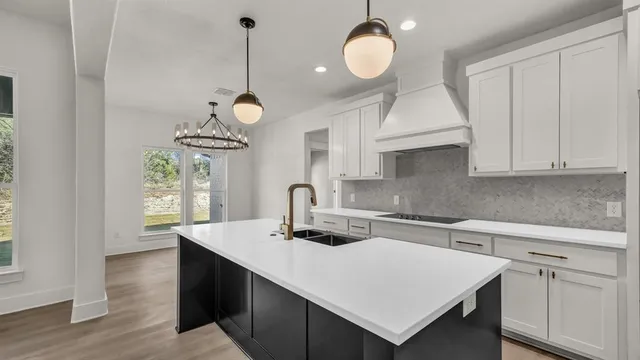 a kitchen with a sink cabinets and window