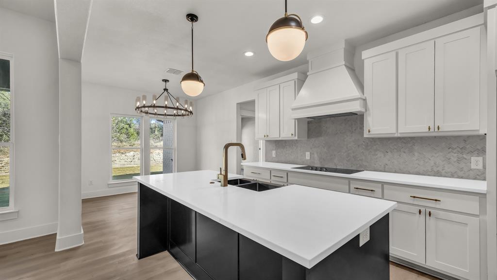 225 Jefferson Way Weatherford, TX 76088 - Photo 6 of 35 a kitchen with a sink cabinets and window