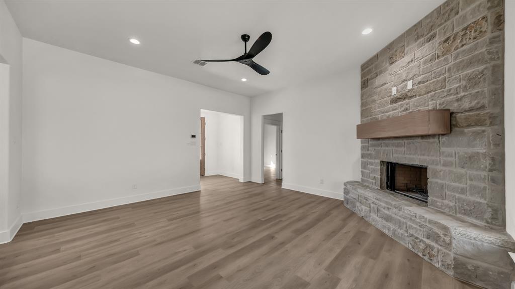 225 Jefferson Way Weatherford, TX 76088 - Photo 7 of 35 a view of empty room with wooden floor and fireplace