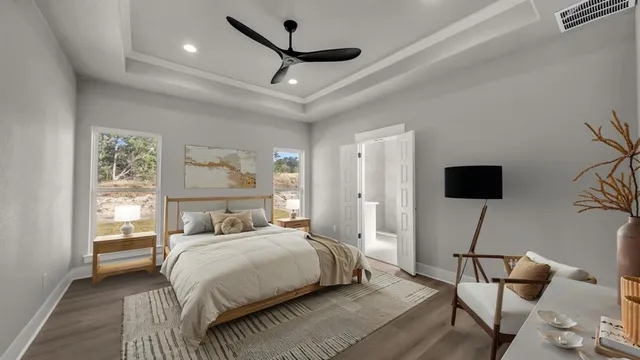 a bedroom with a bed tv and a window