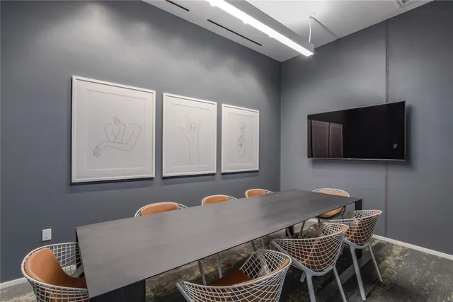a dining room with furniture and a flat screen tv