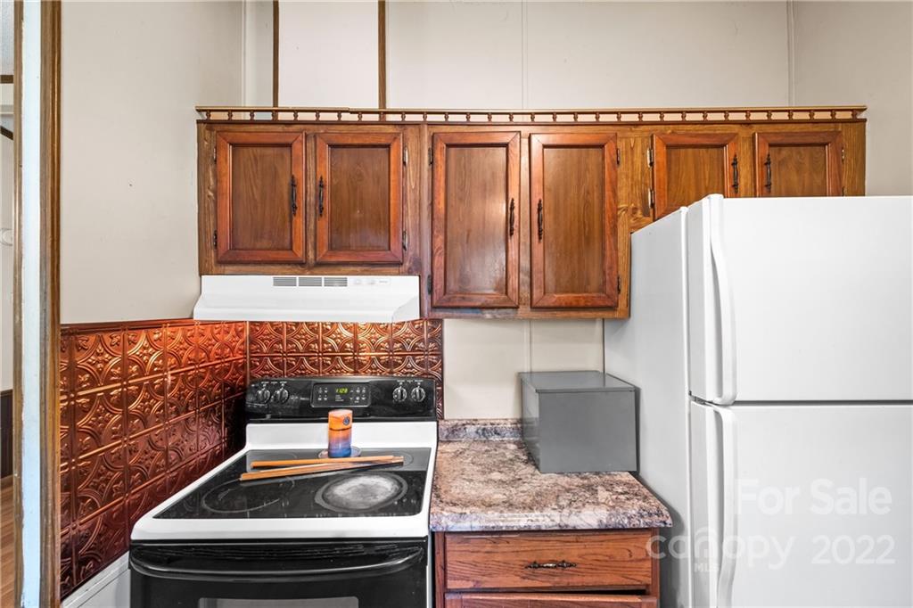 1935 Brian Kelley Lane Fort Mill, SC 29708 - Photo 7 of 33 a kitchen with granite countertop a refrigerator and a stove