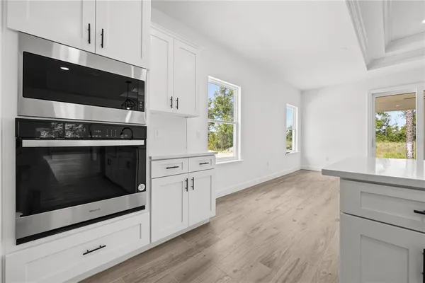 a kitchen with stainless steel appliances a stove microwave and sink
