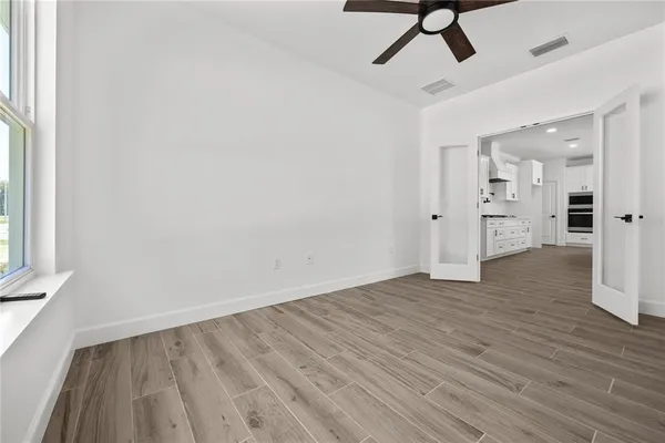 wooden floor in an empty room with a window