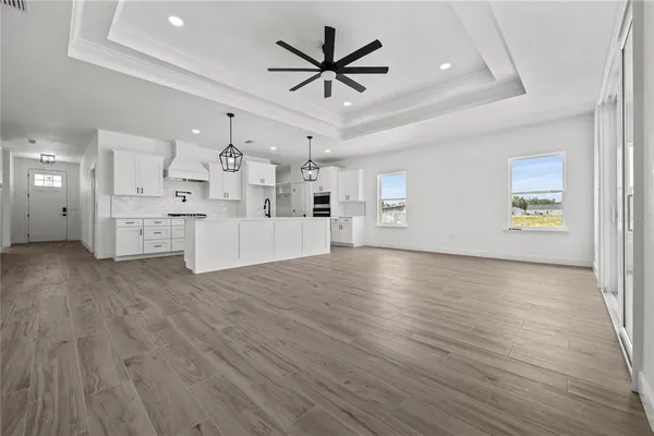 a view of a kitchen with furniture and wooden floor