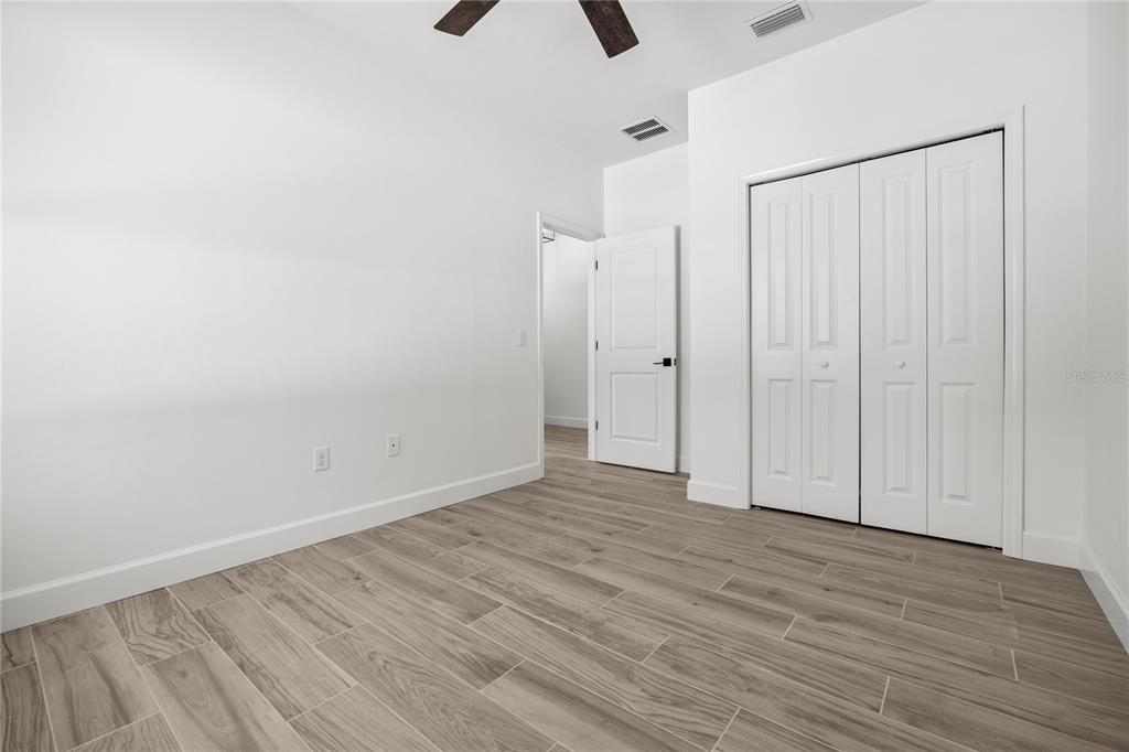 1050 Southwest 67th Drive Gainesville, FL 32607 - Photo 26 of 28 a view of an empty room with wooden floor