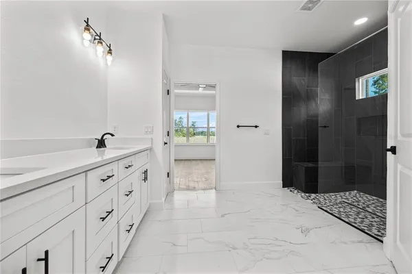 a spacious bathroom with a shower and a sink