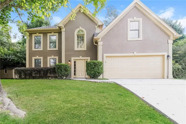 a front view of a house with a yard