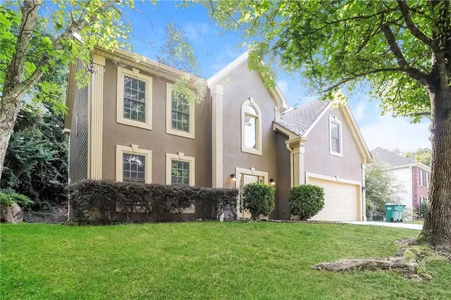 a view of a brick house with a yard