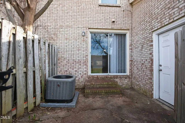 a view of a house with brick walls
