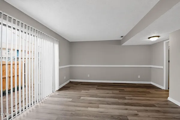 a view of a room with wooden floor and bench