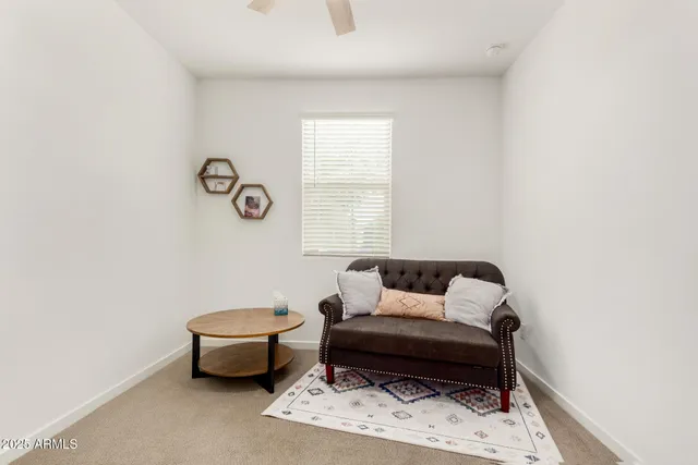 an empty room with a window and ceiling fan