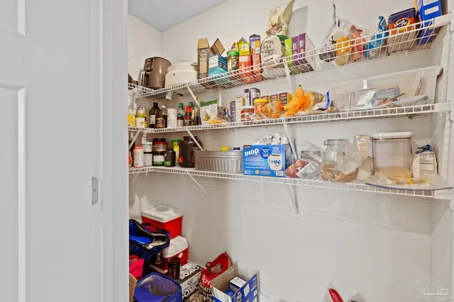 a utility room with lots of clutter and cabinets