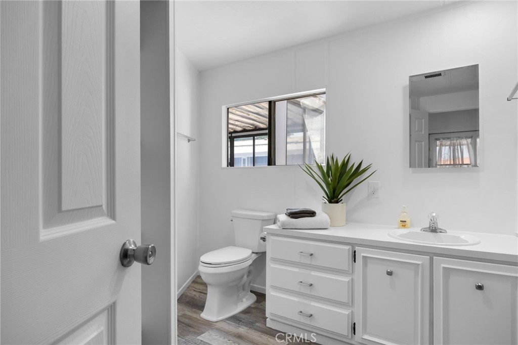995 Pomona Road, Unit 88 Corona, CA 92882 - Photo 13 of 31 a bathroom with a toilet a sink and mirror