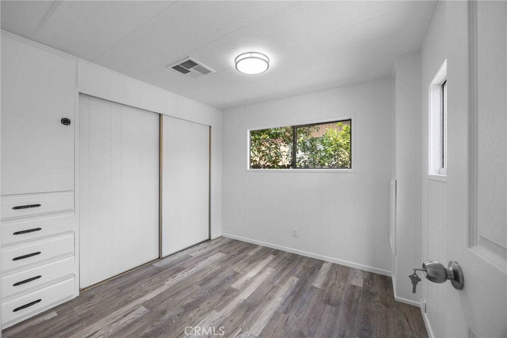 995 Pomona Road, Unit 88 Corona, CA 92882 - Photo 17 of 31 a view of empty room with wooden floor
