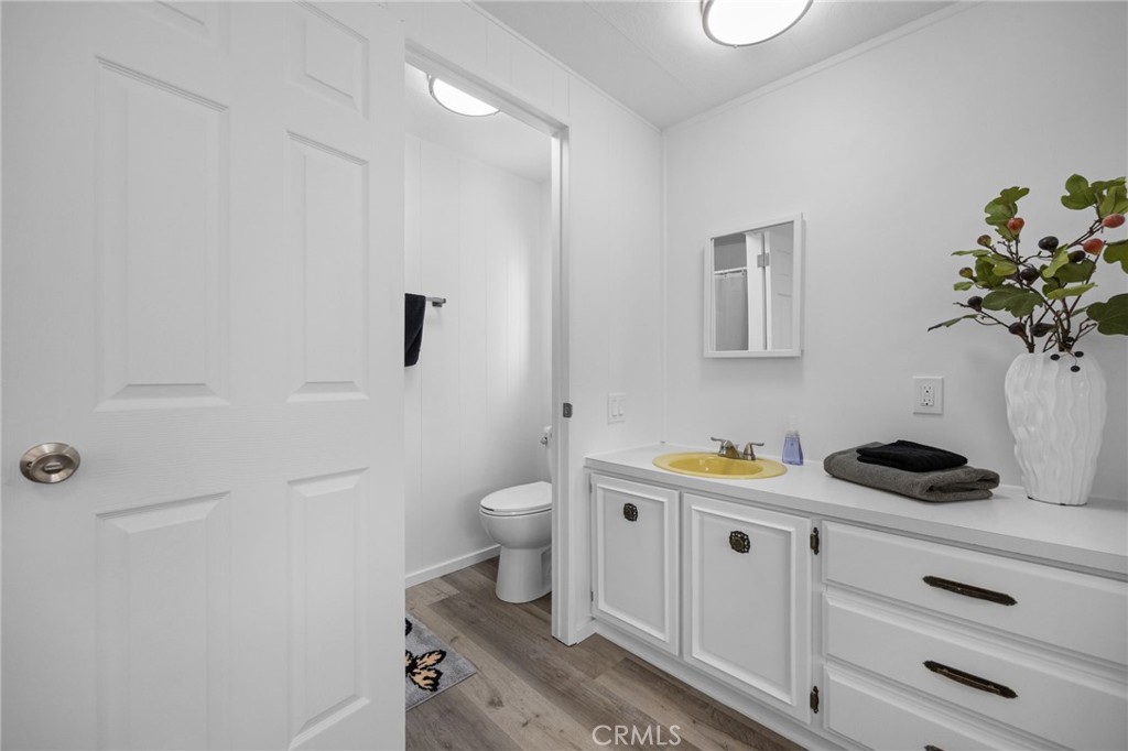 995 Pomona Road, Unit 88 Corona, CA 92882 - Photo 18 of 31 a bathroom with a sink a toilet and vanity