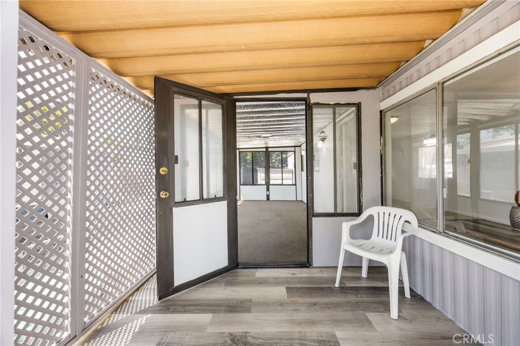 995 Pomona Road, Unit 88 Corona, CA 92882 - Photo 7 of 31 a hallway with a chair and a large window with outdoor views