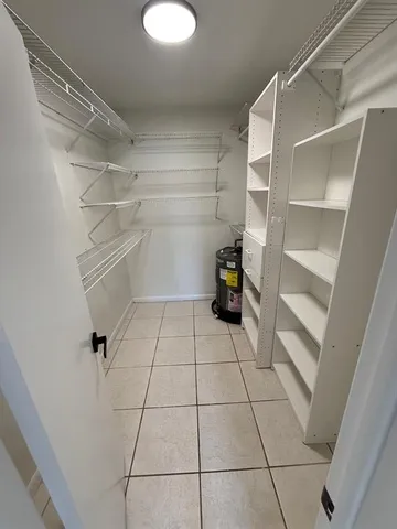 a view of storage and utility room with racks on the wall