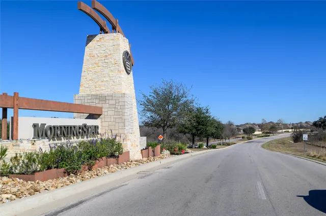 a view of a tall building with a small yard
