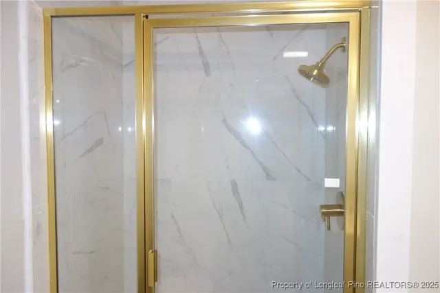a bathroom with a glass shower door and a mirror