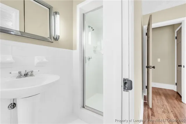 a bathroom with a toilet a sink a mirror and vanity