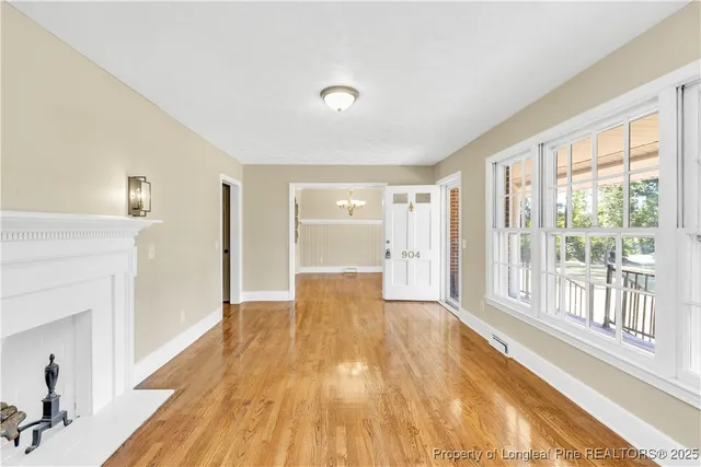 a view of empty room with wooden floor