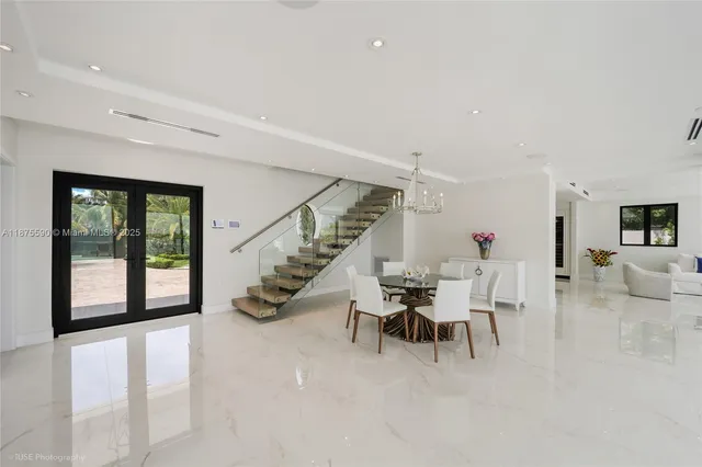 a view of a dining room with furniture wooden floor and chandelier