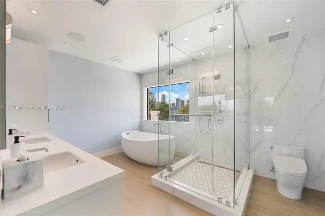 a white bath tub sitting next to a window