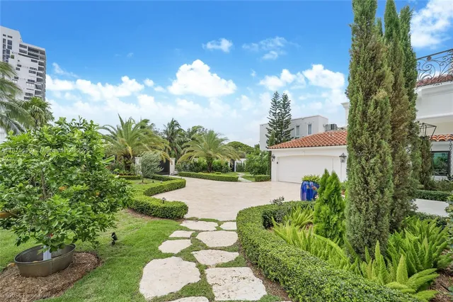 a view of a garden with a building in the background