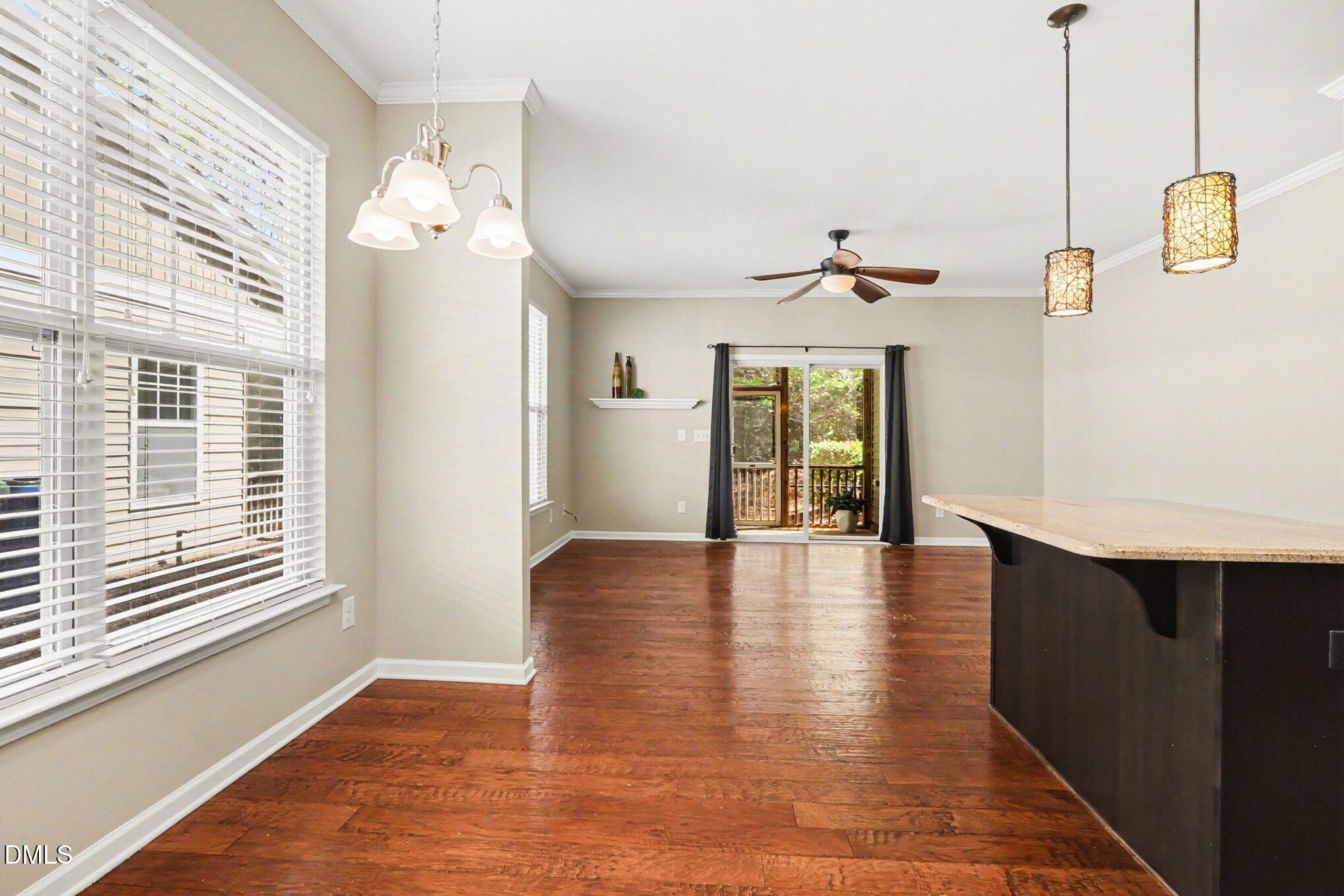 2409 Memory Ridge Drive Raleigh, NC 27606 - Photo 12 of 36 a view of an empty room with wooden floor and a window