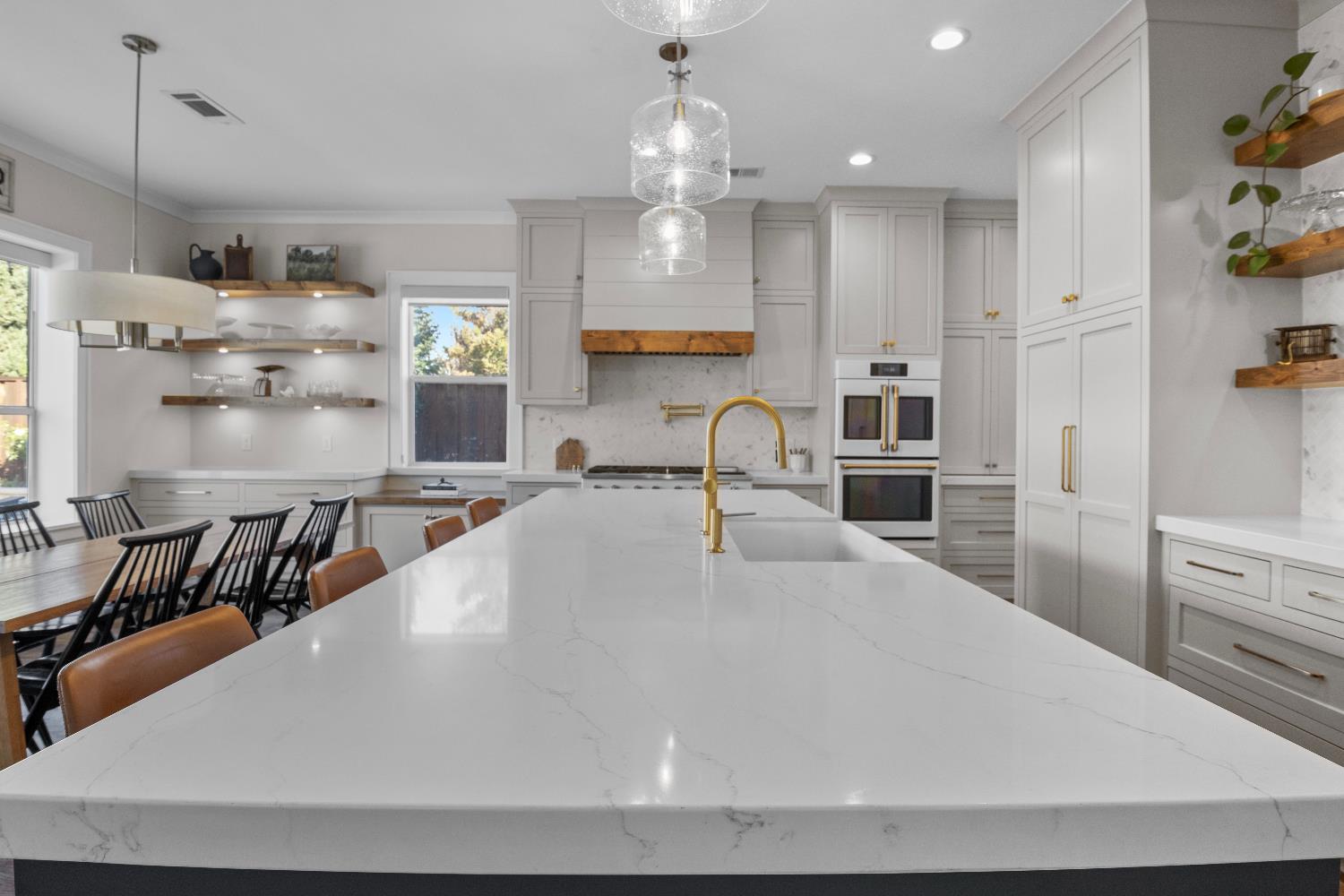 637 Rebekah Court Ripon, CA 95366 - Photo 1 of 69 a large white kitchen with lots of counter space and chandelier