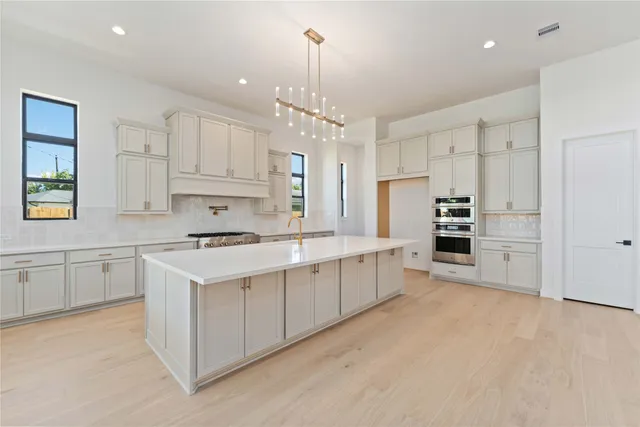 a view of an empty room with a fireplace and a window